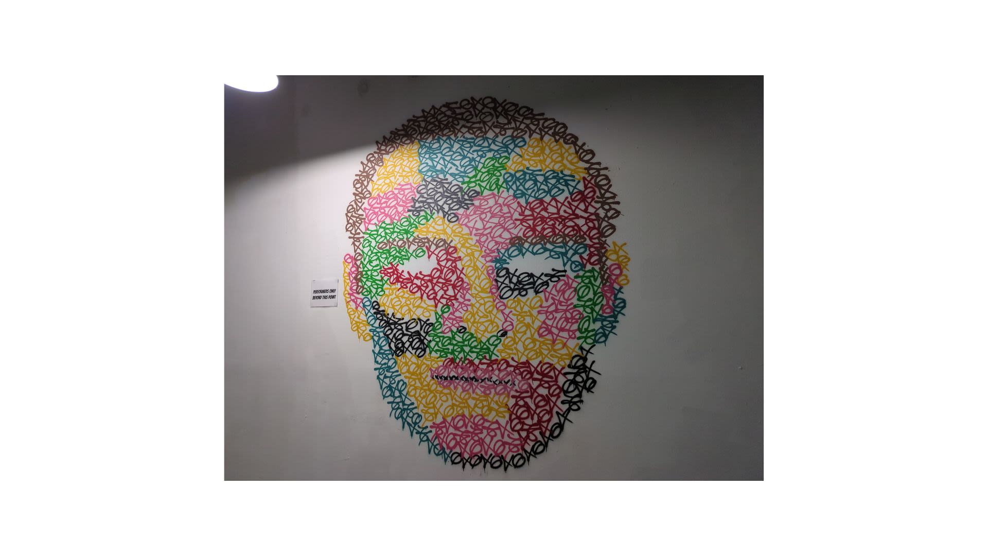 A multicolored wall mural of a head and face.