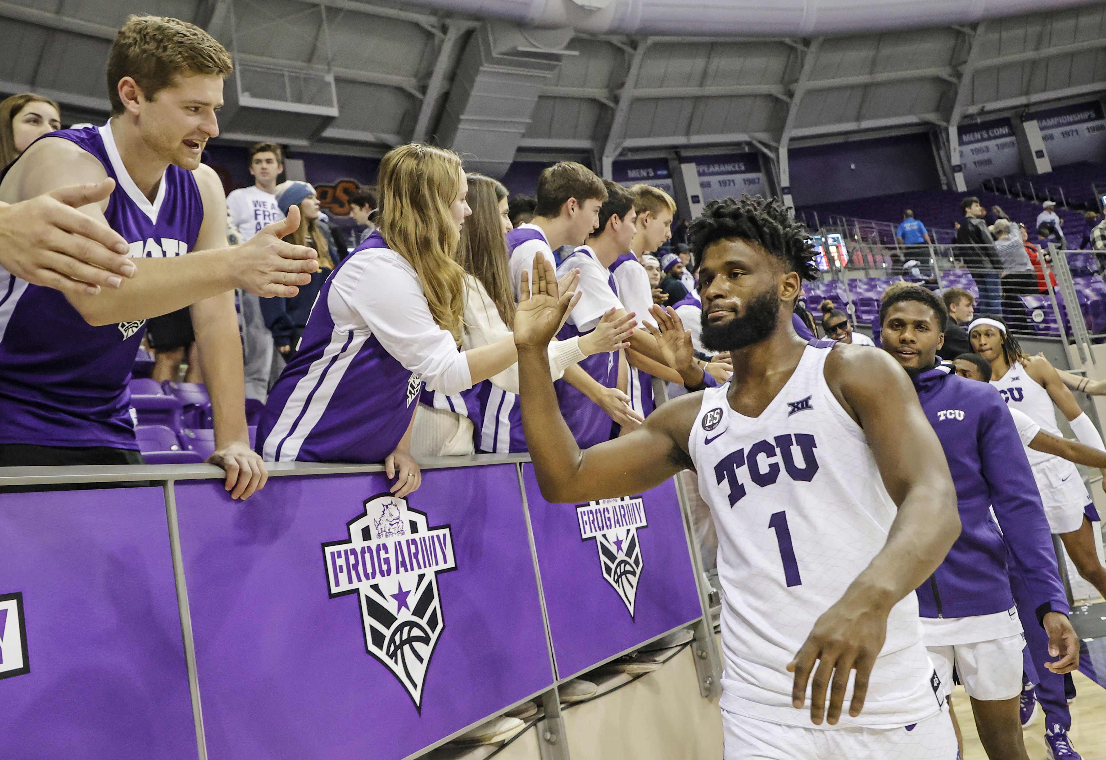 Miles high fives the TCU Frog Army after a home win during the 2021-2022 season. (Photo courtesy of gofrogs.com)