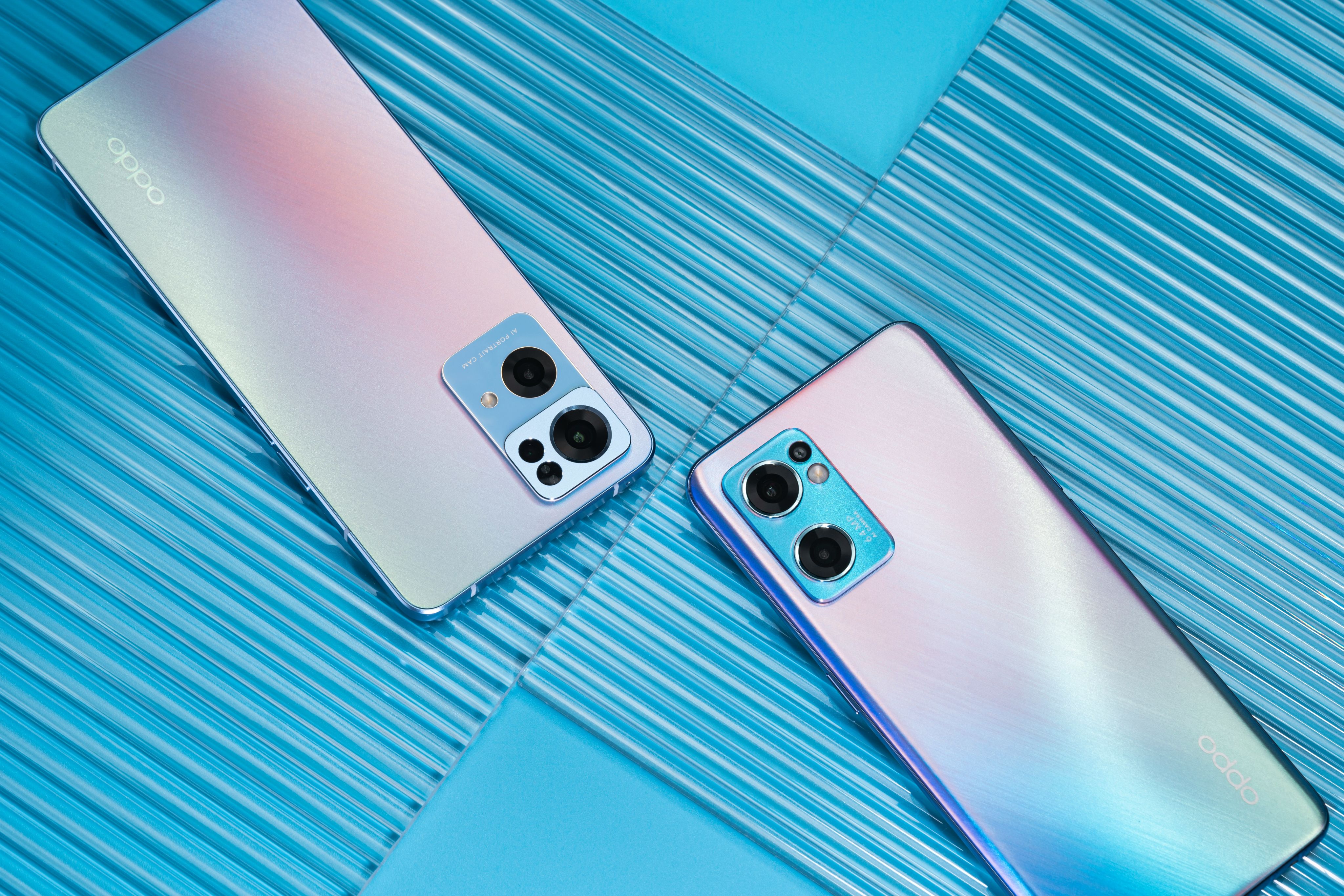 two new cell phones are laying side by side